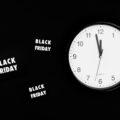 A black friday sale signage beside a black and white round analog wall clock