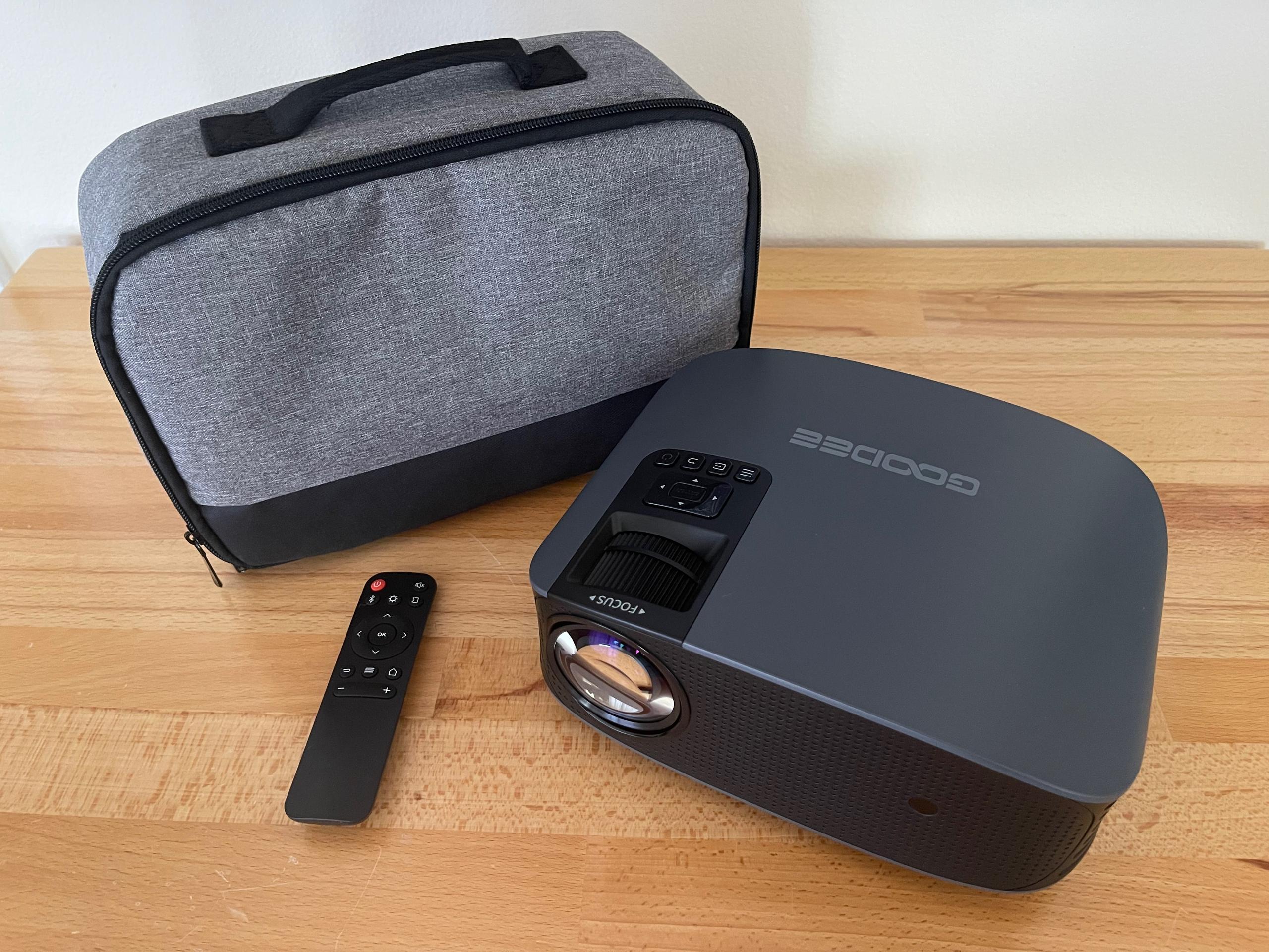 GooDee Y600 Plus Video Projector, a bag and a remote control on a desk
