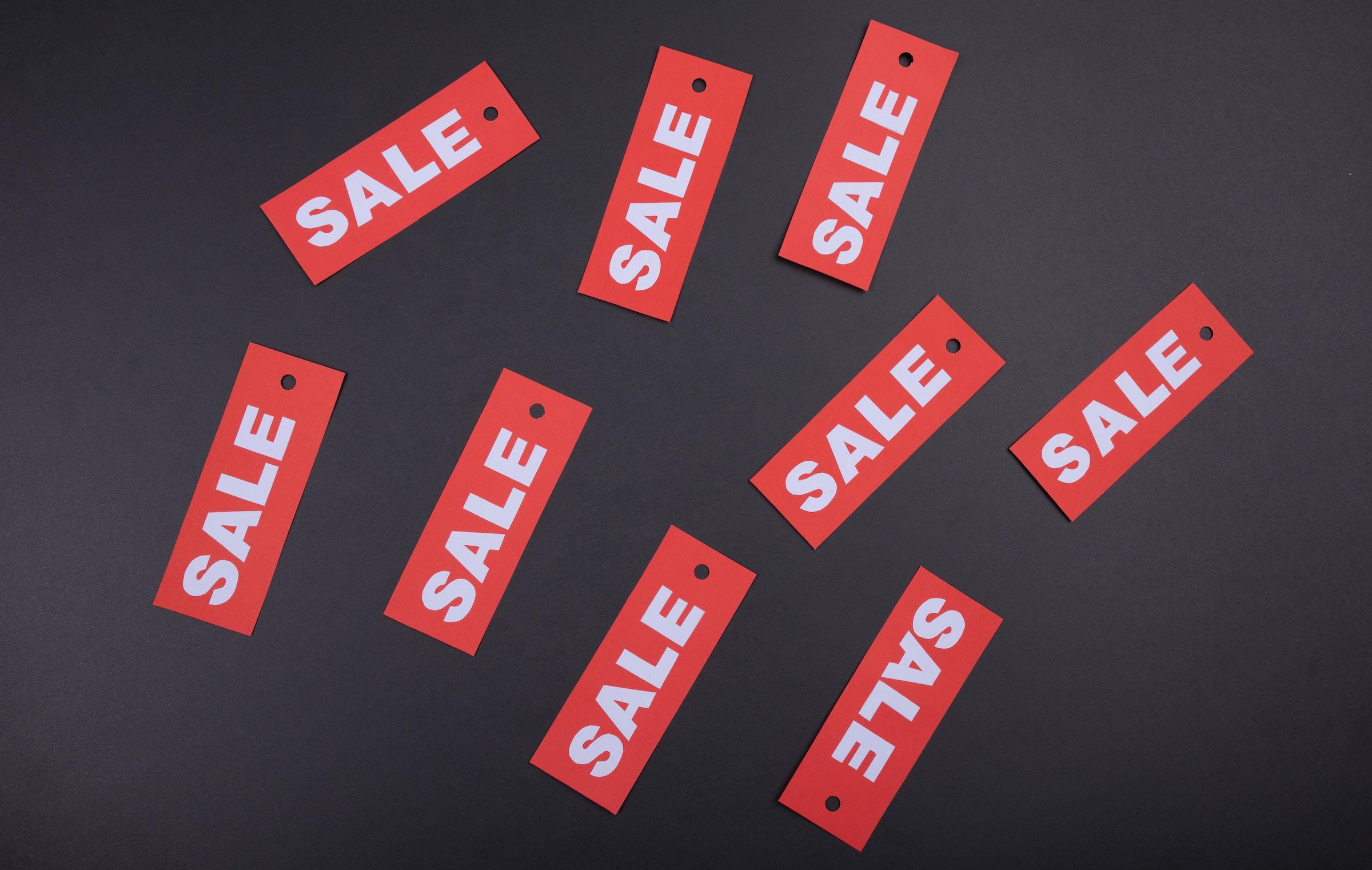Red Sale Signs on Black Background