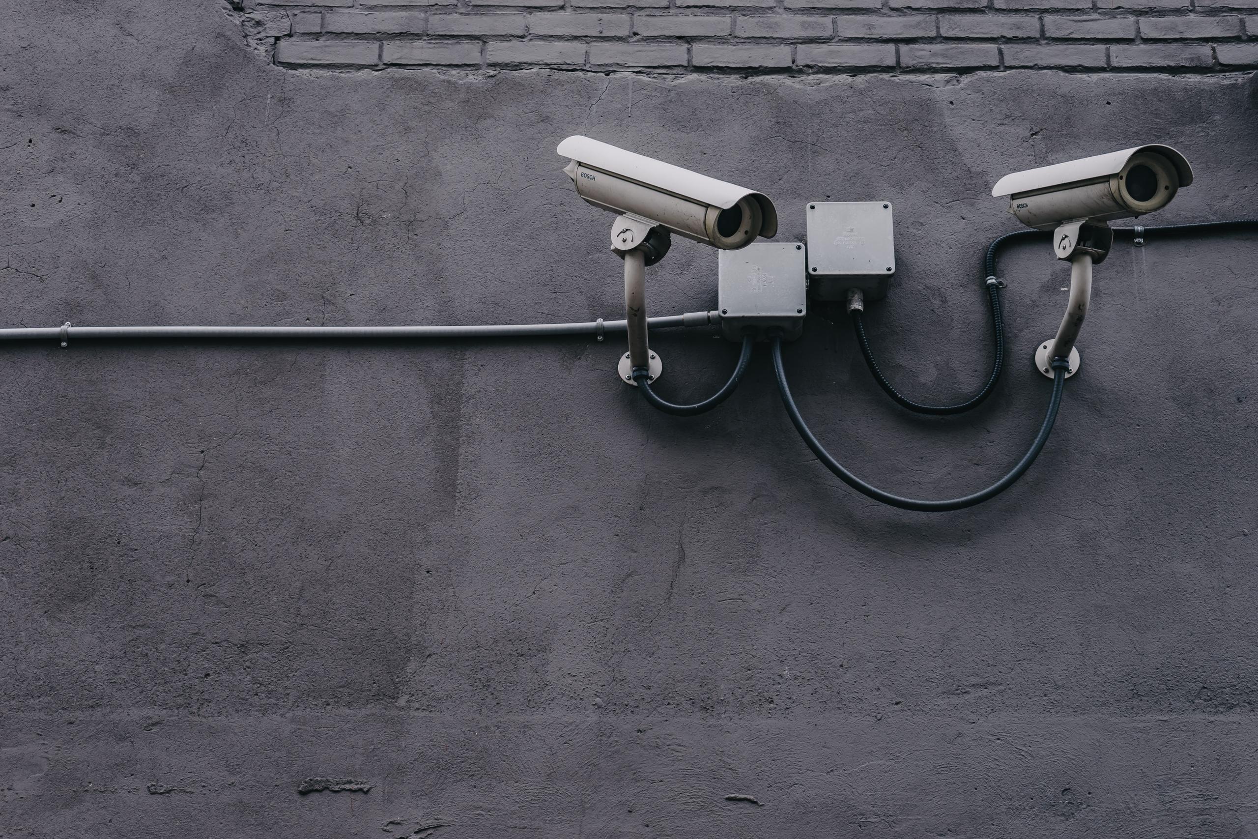 2 security cameras mounted on a wall