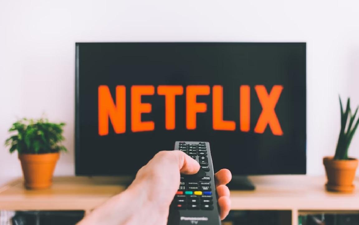 A man browsing Netflix with remote control