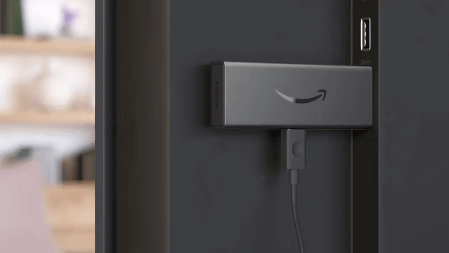 Amazon Fire TV Stick plugged into a TV.