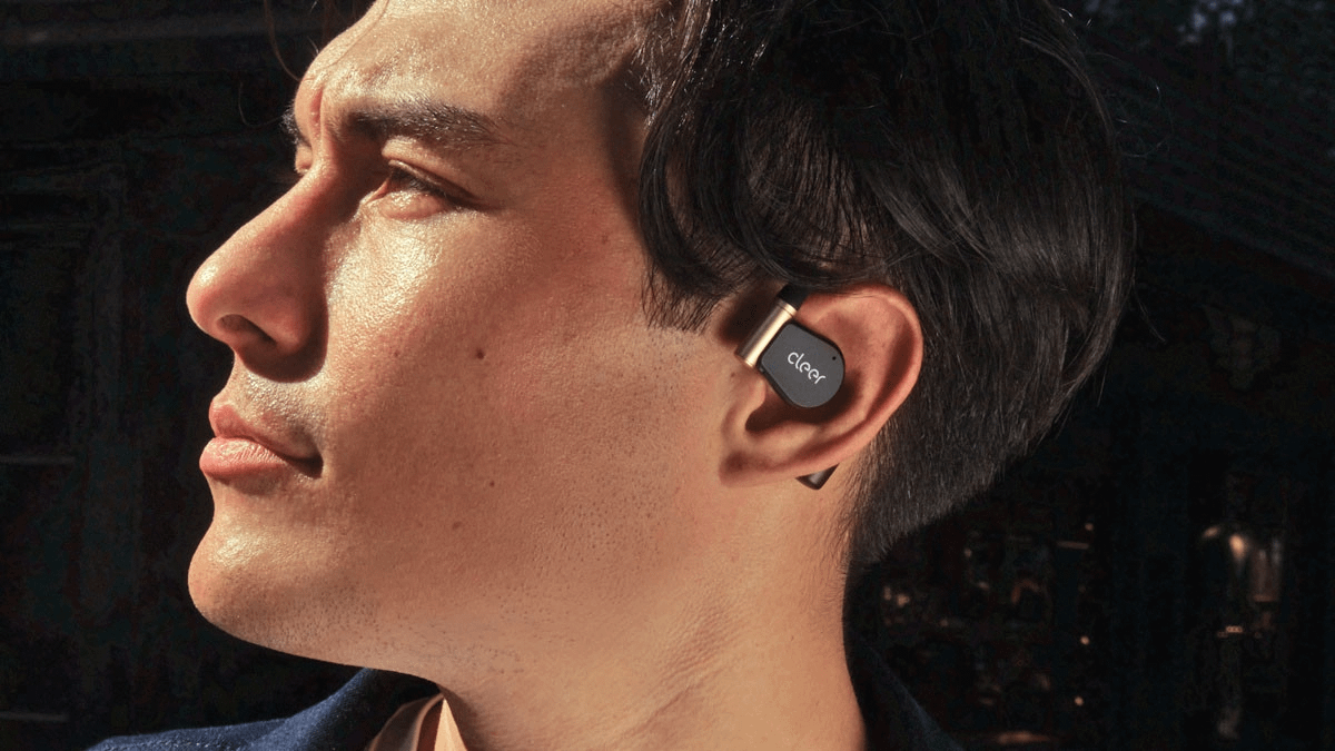 Man wearing Cleer ARC3 earbuds.
