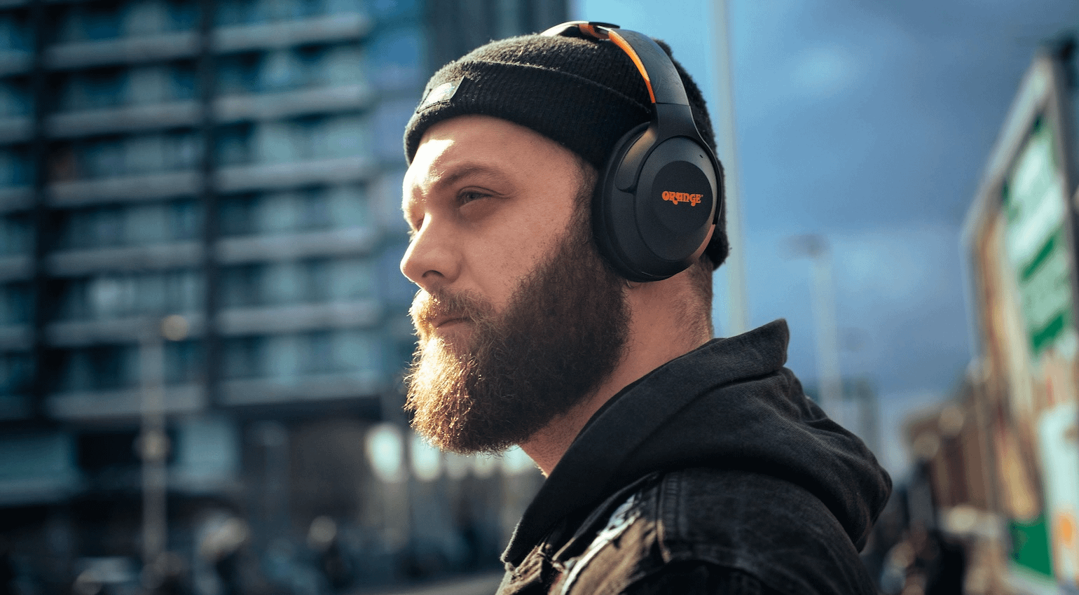Man wearing Orange ‘O’ Edition MKII headphones.