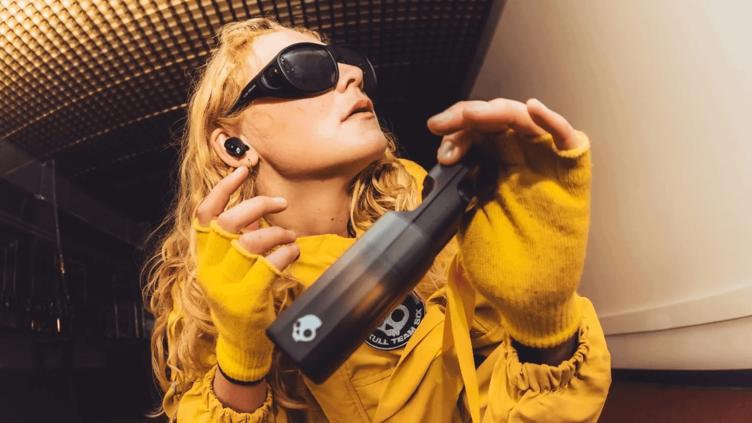 Woman wearing Skullcandy Method 360 ANC earbuds.