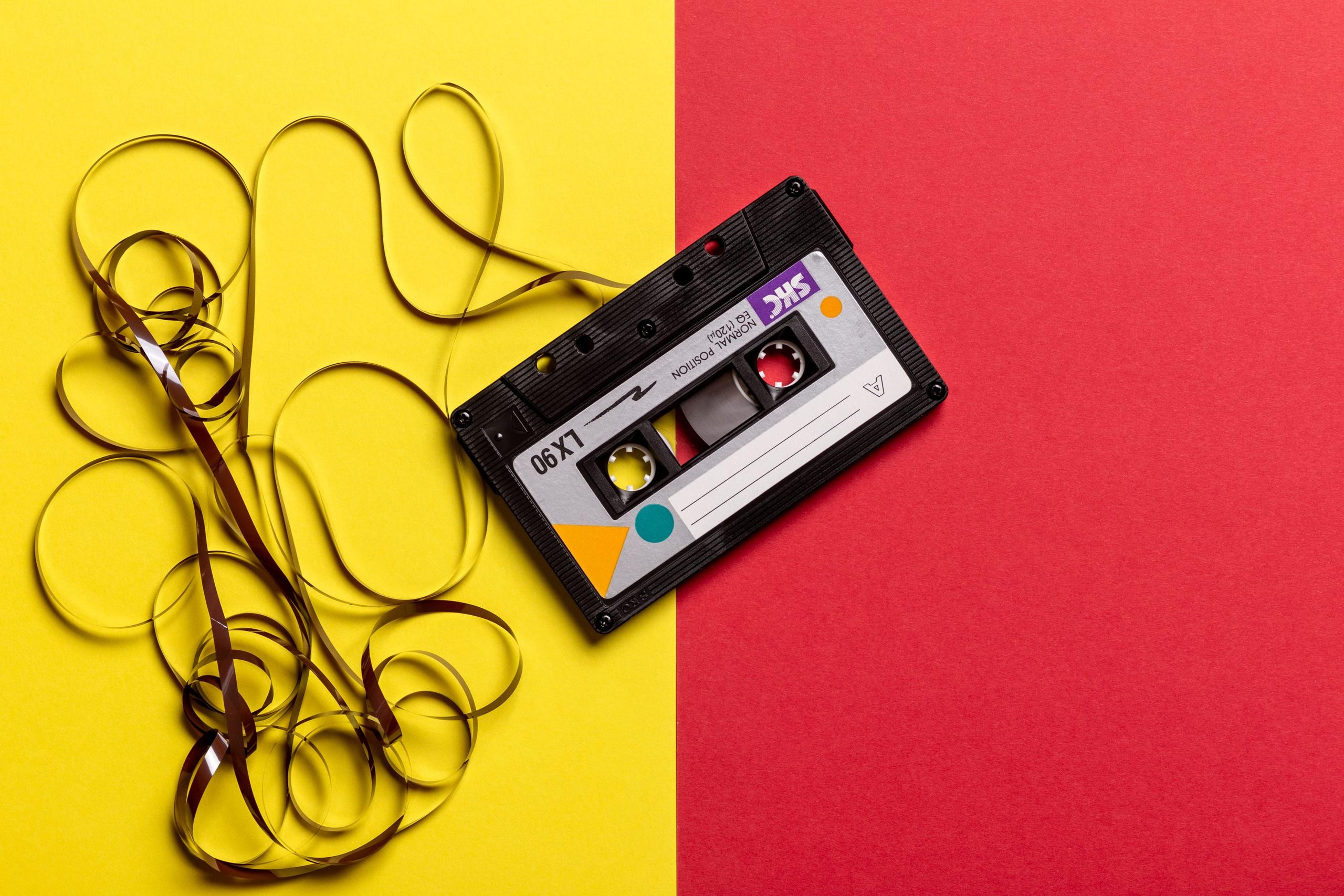 Cassette tape on yellow and red background.