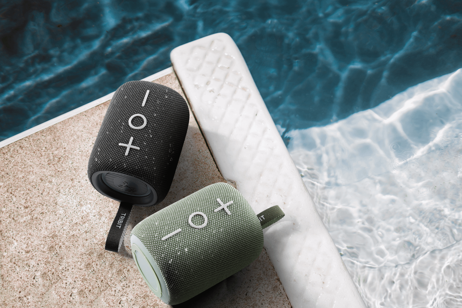 Tribit StormBox Mini Plus Bluetooth speakers in black and green colors.