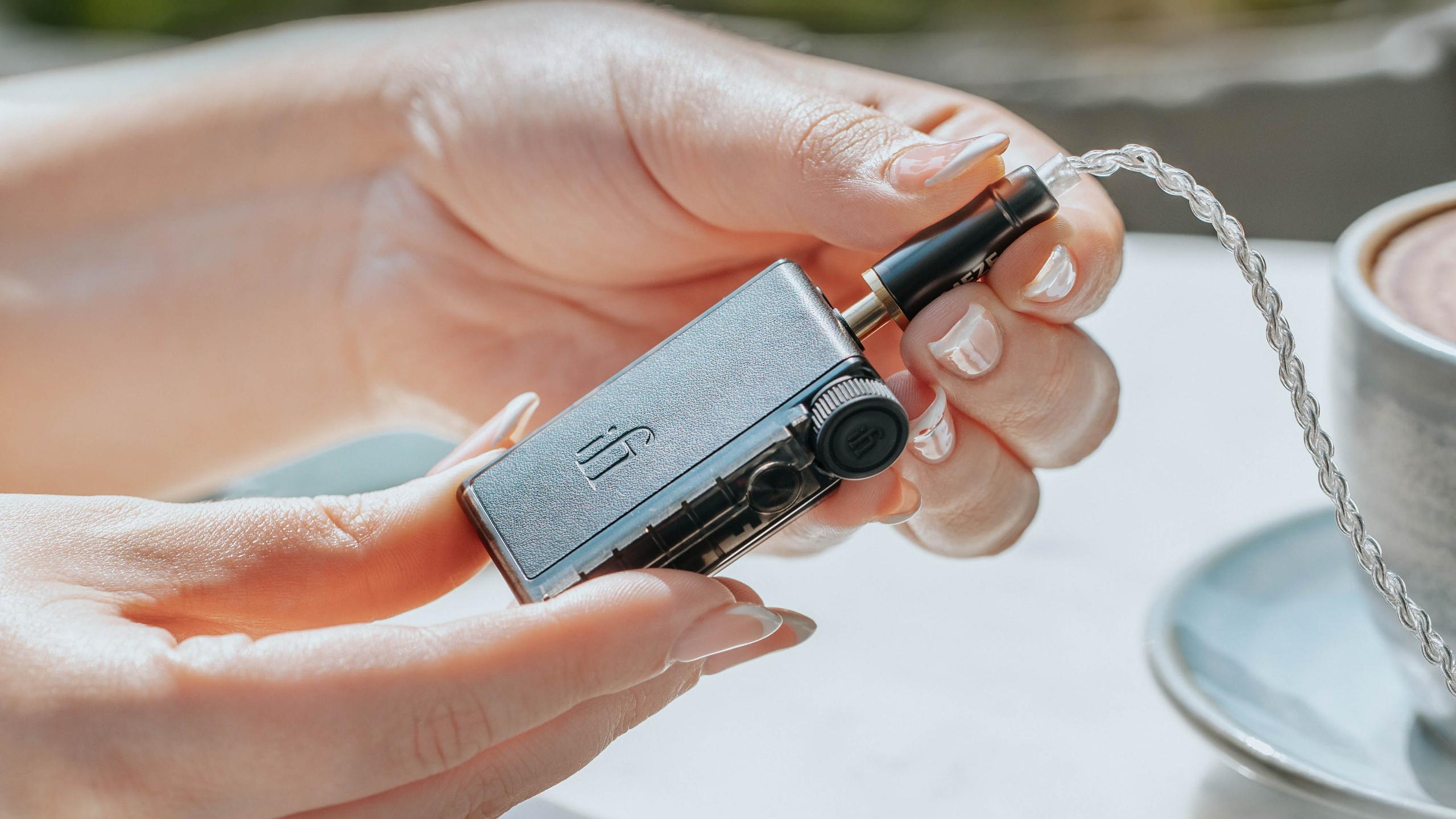 iFi GO blu Air DAC in hand.