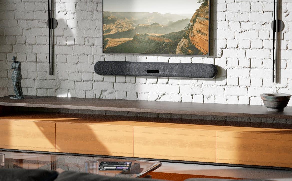 Bluesound Pulse Cinema soundbar on wall in living room.