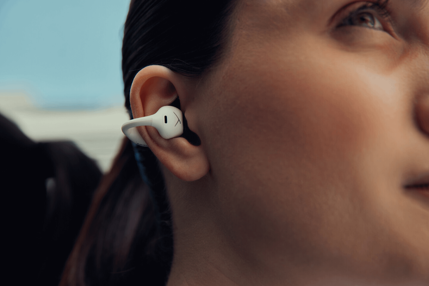 Beyerdynamic Just Dropped 3 New Headphones—and Each One’s Built for a Totally Different Life 5 Woman wearing Beyerdynamic Amiron Zero earbuds.