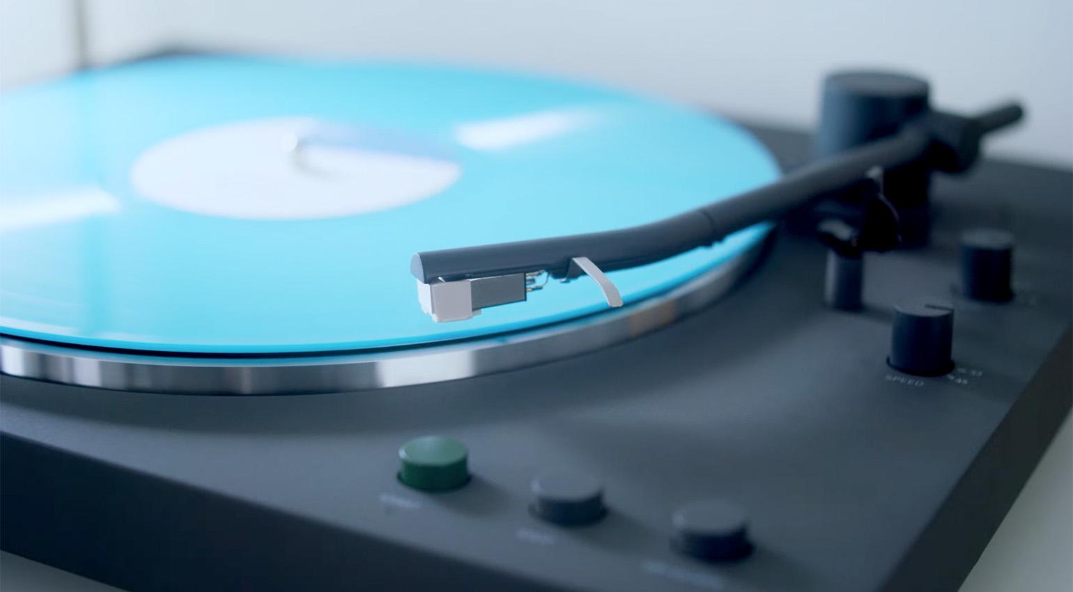Close-up of Sony PS-LX3BT turntable playing a bright blue vinyl record.
