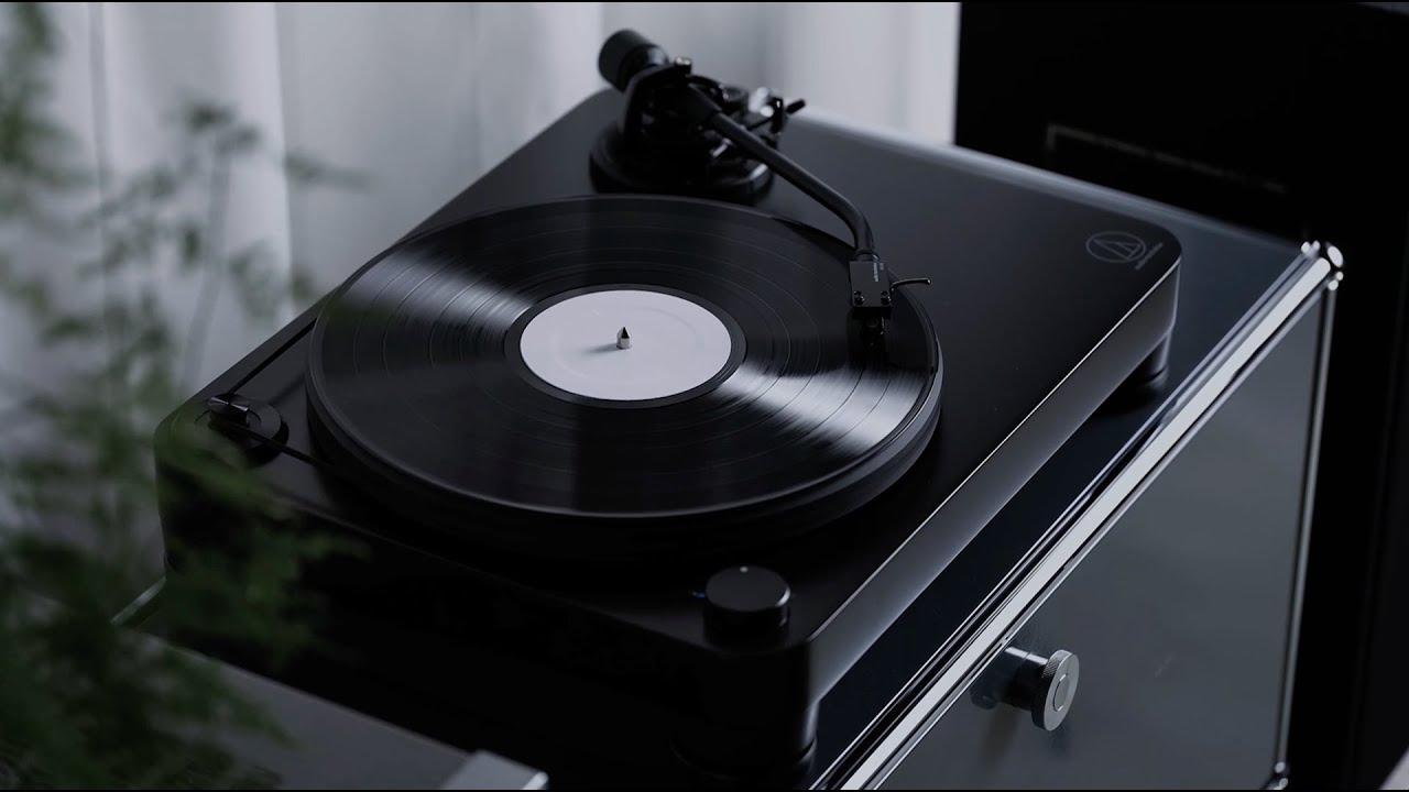 Audio-Technica AT-LP7X turntable with vinyl record on acrylic platter